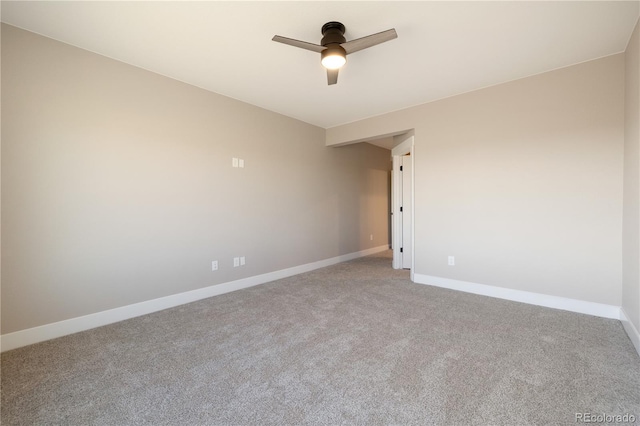 empty room featuring ceiling fan and carpet