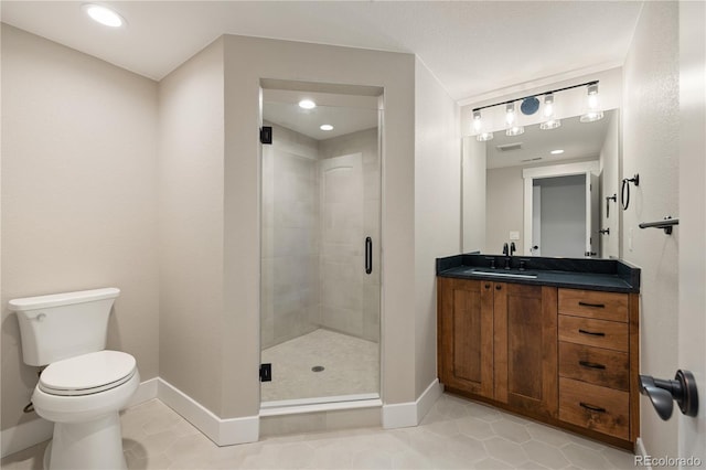 bathroom featuring vanity, an enclosed shower, tile patterned floors, and toilet