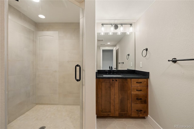 bathroom with vanity, tile patterned flooring, and walk in shower