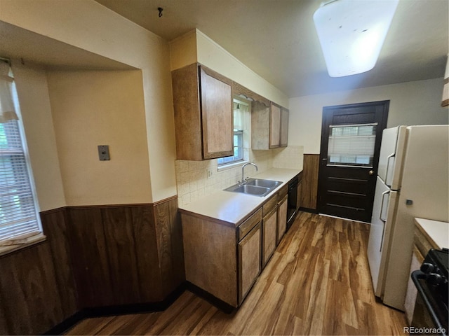912 E 6th Ave, Broomfield, CO 80020 - kitchen featuring a sink, wood finished floors, gas stove, a wainscoted wall, and dishwasher