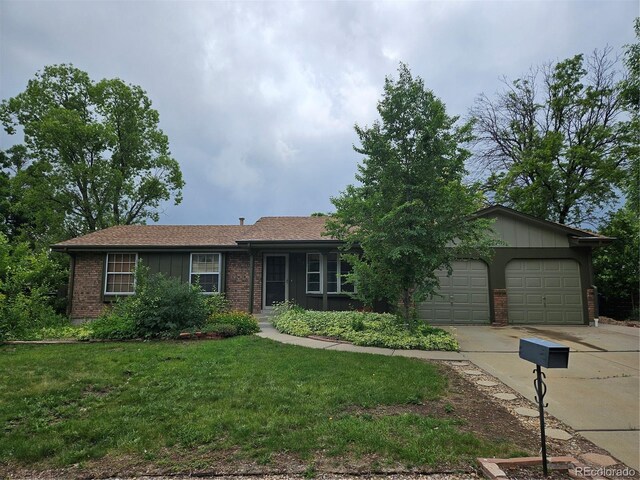 912 E 6th Ave, Broomfield, CO 80020 - ranch-style house featuring driveway, a front lawn, an attached garage, brick siding, and board and batten siding