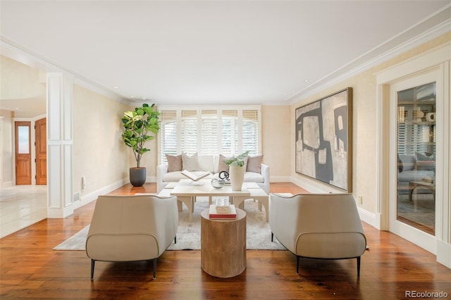 living room with hardwood / wood-style flooring and crown molding