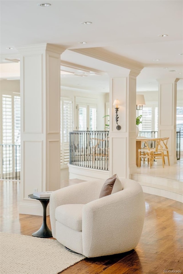 living room featuring hardwood / wood-style flooring and ornamental molding