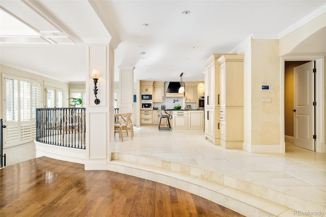 interior space featuring ornamental molding and light hardwood / wood-style floors