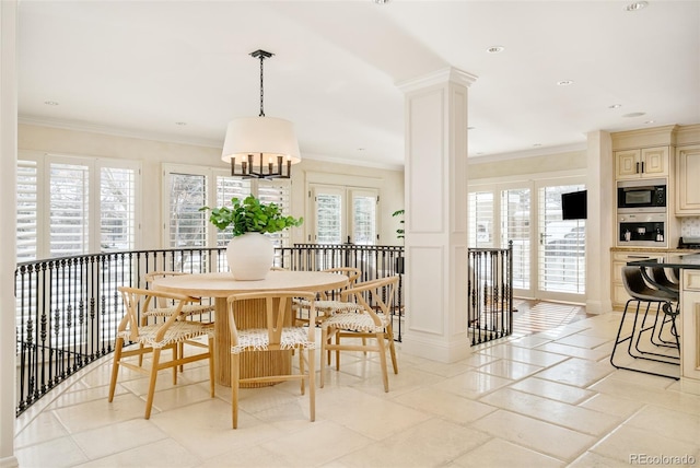 dining area with crown molding, a wealth of natural light, and decorative columns