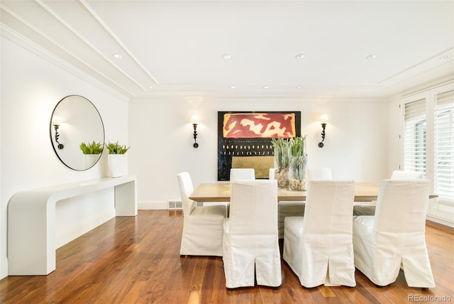 dining area featuring ornamental molding and hardwood / wood-style floors