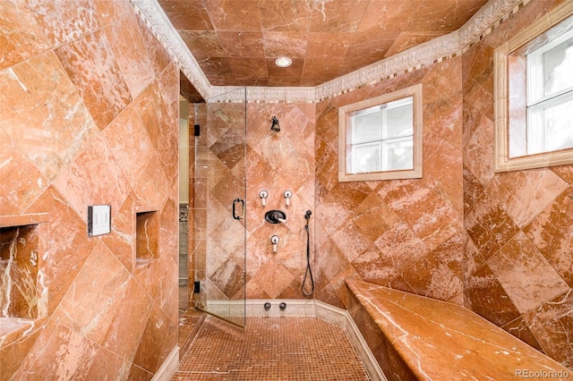 bathroom with tile patterned floors and a tile shower