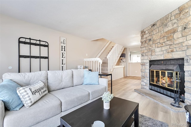 1011 Milo Cir Unit A, Lafayette, CO 80026 - living area with stairs, wood finished floors, and a stone fireplace