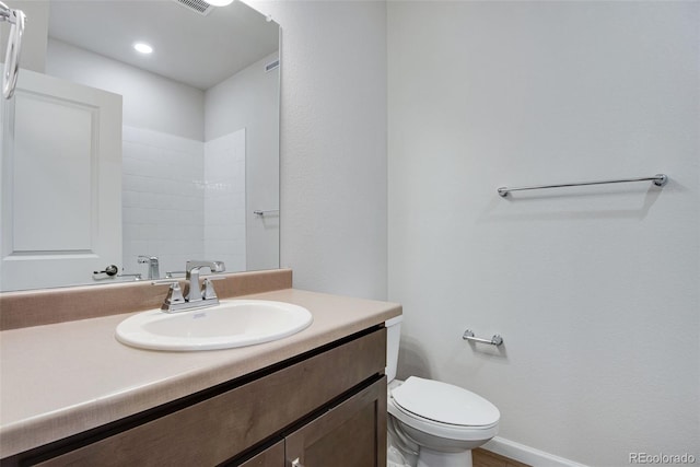 bathroom with vanity and toilet