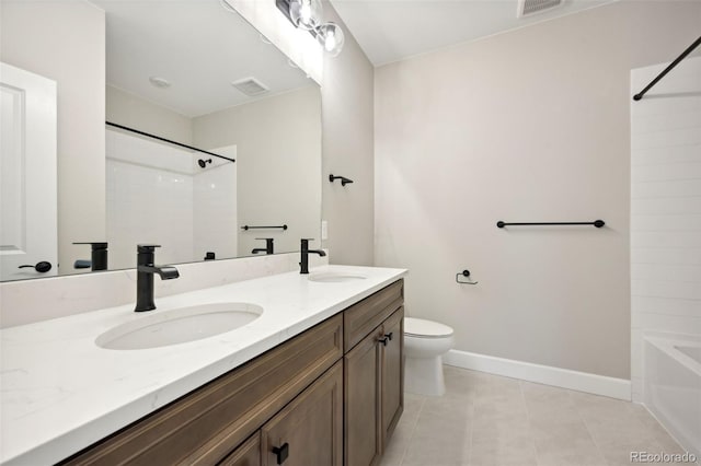 full bathroom featuring double vanity, a sink, toilet, and baseboards