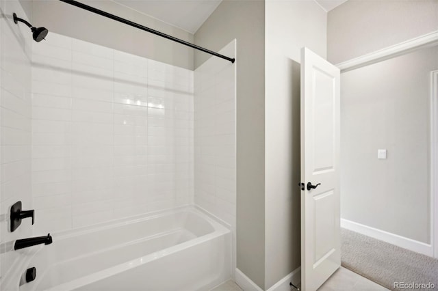 bathroom with bathing tub / shower combination and baseboards