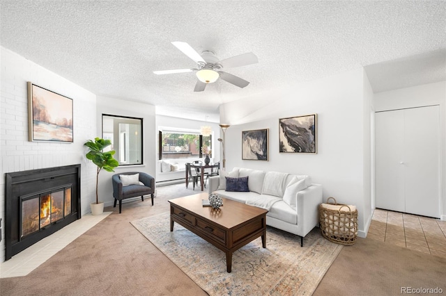 534 E 7th Ave Unit 203, Denver, CO 80203 - living room featuring carpet flooring, a textured ceiling, ceiling fan, and a brick fireplace