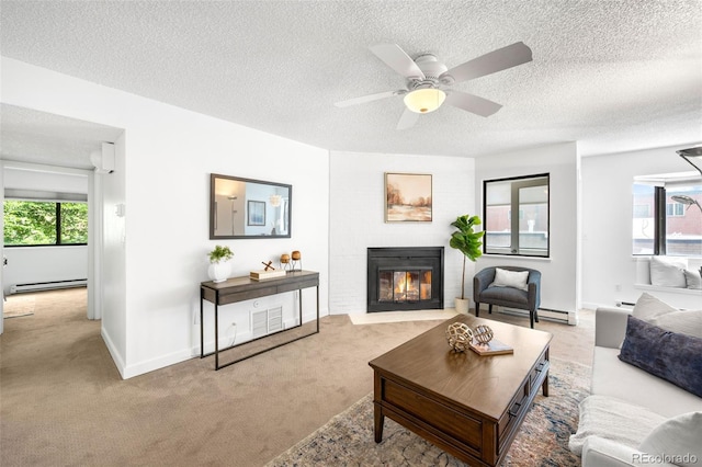 534 E 7th Ave Unit 203, Denver, CO 80203 - living room with baseboard heating, carpet floors, healthy amount of natural light, a fireplace with flush hearth, and a textured ceiling