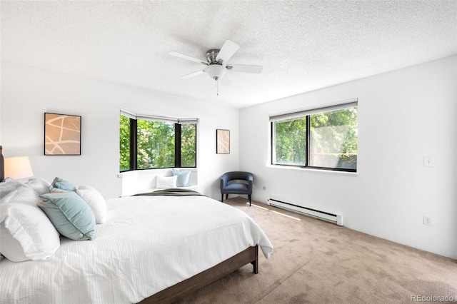 534 E 7th Ave Unit 203, Denver, CO 80203 - carpeted bedroom with baseboard heating, multiple windows, a textured ceiling, and a ceiling fan