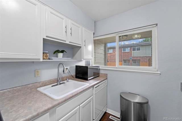 8059 Wolff St Unit C, Westminster, CO 80031 - kitchen with white dishwasher, white cabinets, open shelves, and light countertops