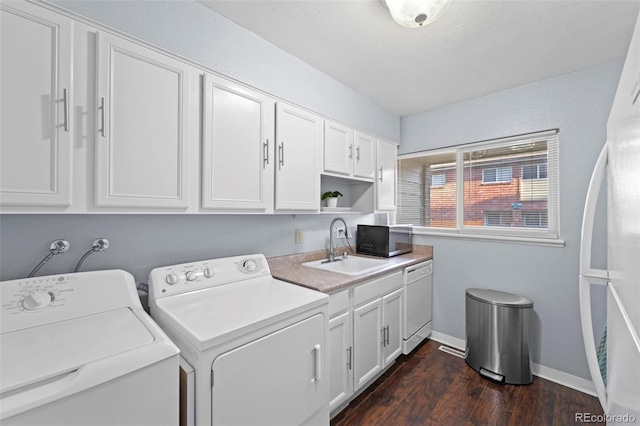 8059 Wolff St Unit C, Westminster, CO 80031 - washroom with washer and clothes dryer, dark wood-style flooring, and cabinet space