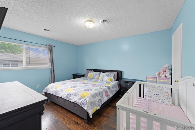 8059 Wolff St Unit C, Westminster, CO 80031 - bedroom with wood finished floors and a textured ceiling