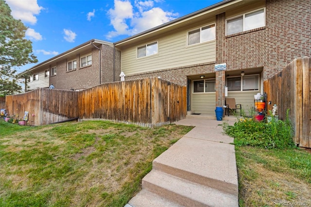 8059 Wolff St Unit C, Westminster, CO 80031 - back of house featuring brick siding and a fenced backyard