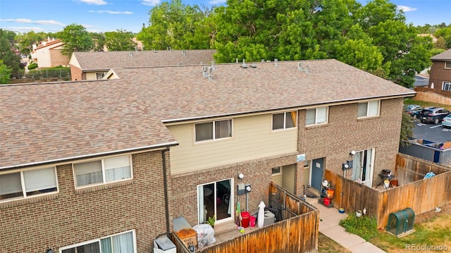 8059 Wolff St Unit C, Westminster, CO 80031 - rear view of house with brick siding and roof with shingles
