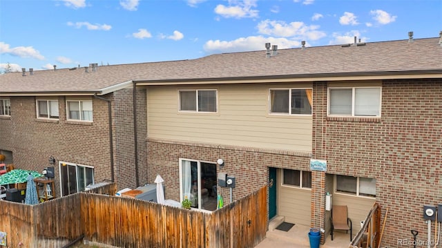 8059 Wolff St Unit C, Westminster, CO 80031 - rear view of property with brick siding and roof with shingles