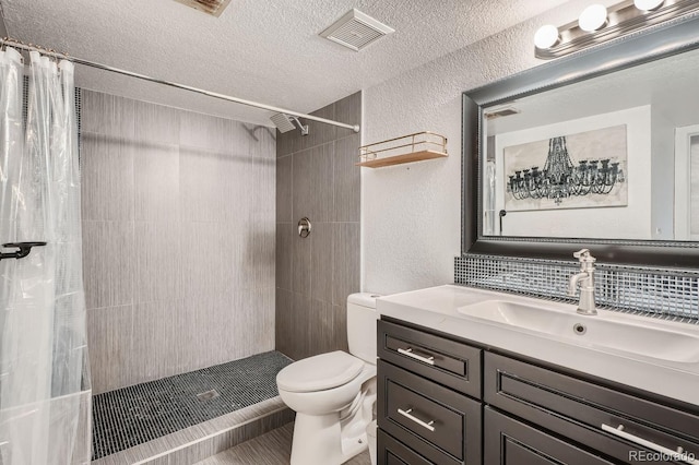 bathroom featuring backsplash, vanity, a textured ceiling, toilet, and a shower with curtain