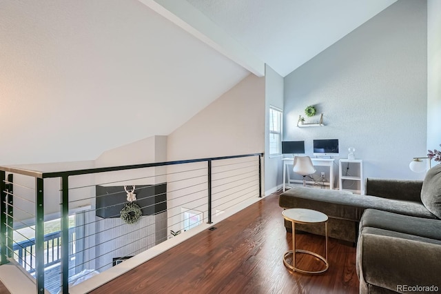 living room with vaulted ceiling with beams and hardwood / wood-style flooring