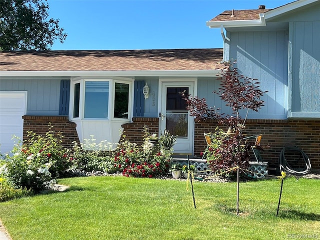 doorway to property featuring a lawn