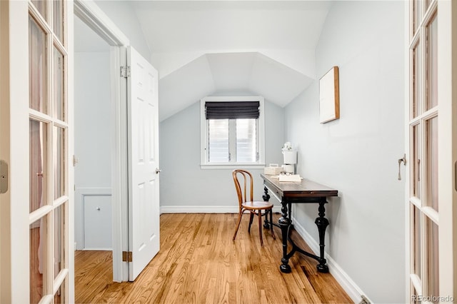 office area featuring lofted ceiling, light wood-type flooring, and french doors