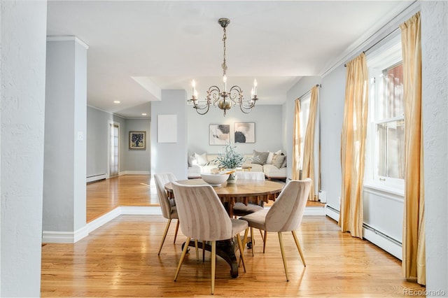 dining space featuring baseboard heating, a chandelier, and light hardwood / wood-style floors