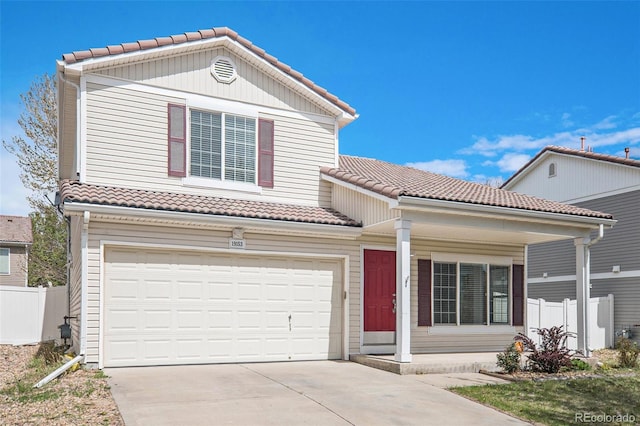 traditional home featuring a tiled roof, a porch, fence, concrete driveway, and an attached garage