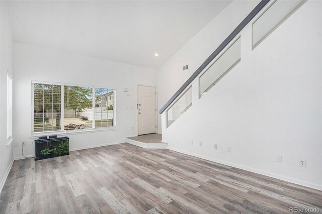 unfurnished living room with recessed lighting, baseboards, visible vents, and wood finished floors