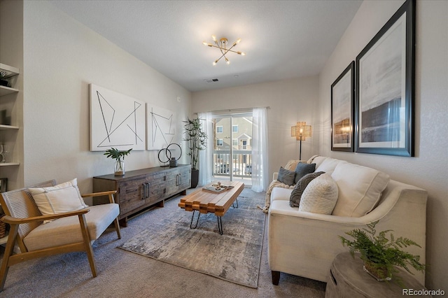 living room with an inviting chandelier and carpet flooring