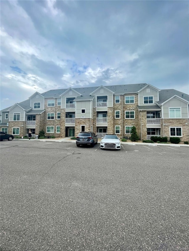1841 S Dunkirk St Unit 203, Aurora, CO 80017 - view of building exterior with uncovered parking and a residential view