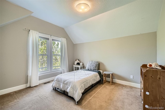 bedroom featuring carpet flooring, baseboards, visible vents, and lofted ceiling