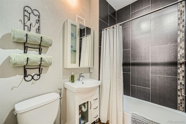 bathroom featuring vanity, shower / tub combo, a textured wall, and toilet