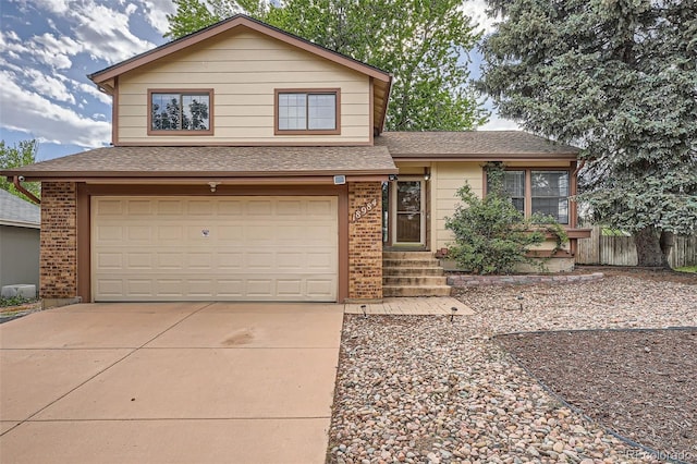 18984 E Kent Cir, Aurora, CO 80013 - tri-level home with a garage, brick siding, concrete driveway, and roof with shingles