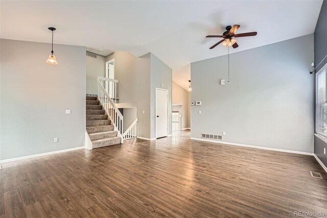 18984 E Kent Cir, Aurora, CO 80013 - unfurnished living room featuring a ceiling fan, wood finished floors, stairs, baseboards, and high vaulted ceiling