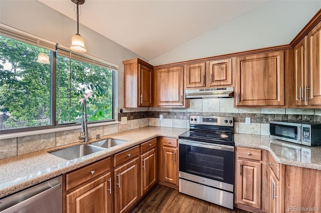 18984 E Kent Cir, Aurora, CO 80013 - kitchen with appliances with stainless steel finishes, under cabinet range hood, a sink, vaulted ceiling, and brown cabinetry