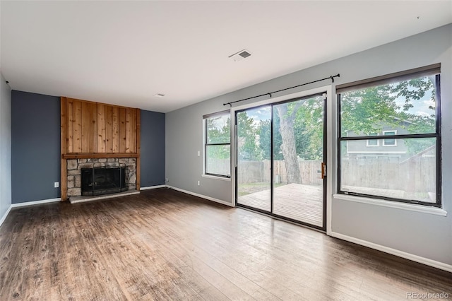 18984 E Kent Cir, Aurora, CO 80013 - unfurnished living room featuring baseboards, wood finished floors, and a fireplace