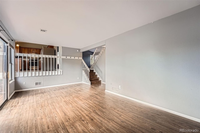 18984 E Kent Cir, Aurora, CO 80013 - empty room with wood finished floors, stairway, and baseboards