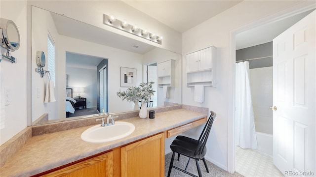 bathroom with tile patterned floors, shower / tub combo with curtain, connected bathroom, and vanity