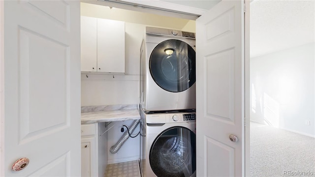 laundry area featuring stacked washing maching and dryer and laundry area