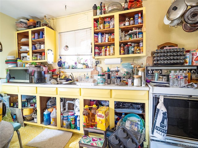 interior space with stainless steel microwave, electric range, and open shelves