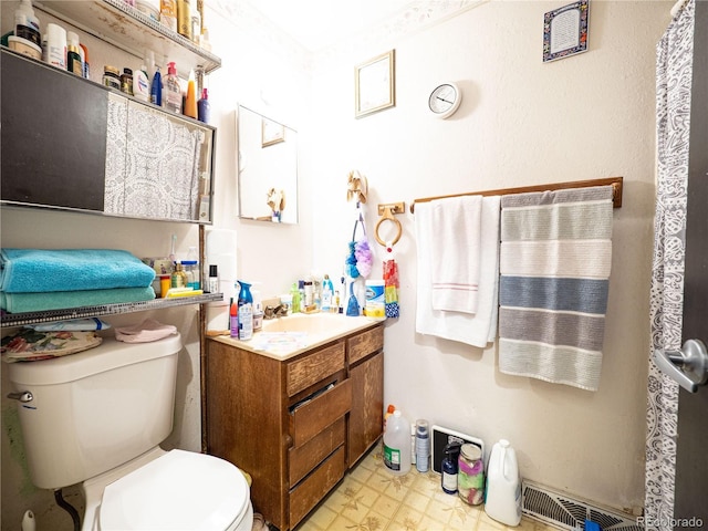 bathroom featuring toilet, visible vents, vanity, and tile patterned floors