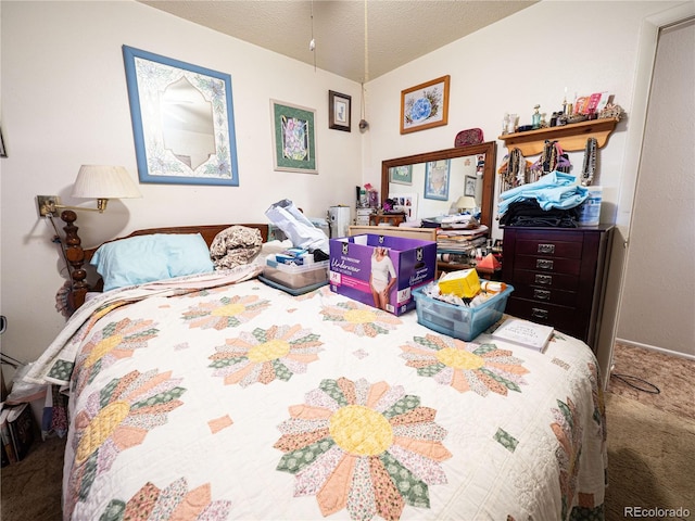 bedroom with a textured ceiling and carpet floors