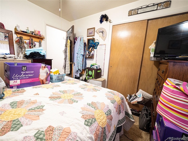 bedroom featuring a textured ceiling and a closet