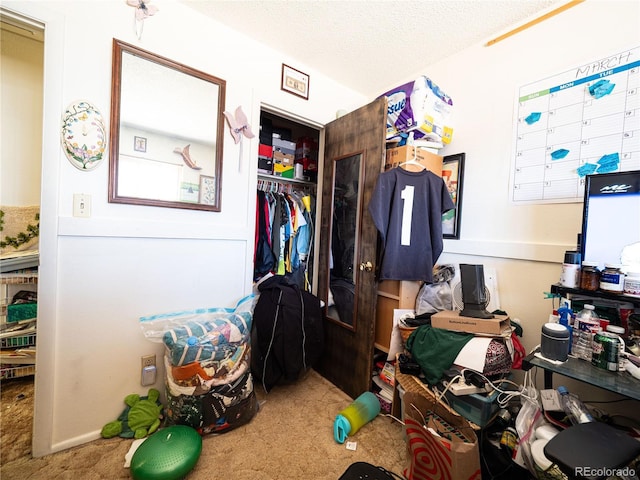 carpeted bedroom with a textured ceiling and a closet