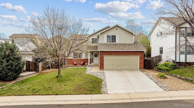 traditional-style house featuring fence, a front lawn, brick siding, a garage, and concrete driveway