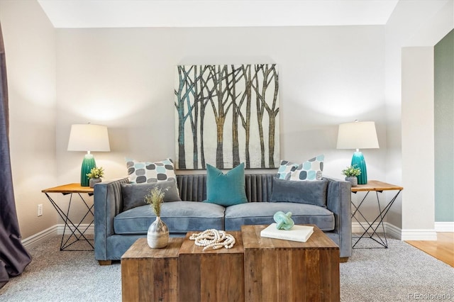 living room featuring carpet flooring and baseboards