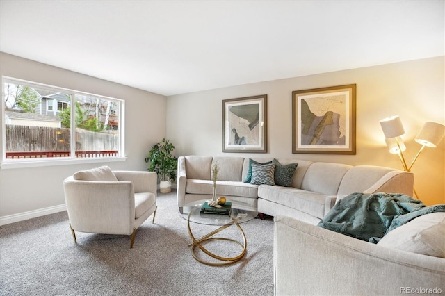 carpeted living area with baseboards
